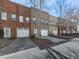 View of brick townhomes with attached garages and driveways at 121 Riverwatch Ct, Canton, GA 30114