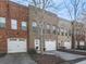Charming brick townhomes featuring attached garages and well-maintained landscaping at 121 Riverwatch Ct, Canton, GA 30114