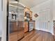 Modern kitchen with stainless steel refrigerator and oven, wooden cabinets, and white door at 121 Riverwatch Ct, Canton, GA 30114