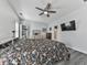 Bright bedroom features hardwood floors, ceiling fan, a dresser, and a door to the balcony at 121 Riverwatch Ct, Canton, GA 30114