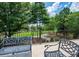 View from the balcony featuring wrought iron benches, lush green trees, and a golf course in the distance at 3299 Carmichael Pl, Duluth, GA 30097