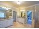 A spacious bathroom featuring dual vanities with granite countertops and tile flooring at 3299 Carmichael Pl, Duluth, GA 30097