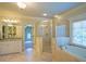 Bright bathroom features a glass shower, soaking tub, double sink vanity, and neutral tones at 3299 Carmichael Pl, Duluth, GA 30097