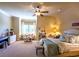 Bright, spacious bedroom with sloped ceilings, a ceiling fan, and a cozy sitting area at 3299 Carmichael Pl, Duluth, GA 30097