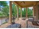 Inviting covered porch with brick flooring, elegant columns, ceiling fan, and views of the lush backyard at 3299 Carmichael Pl, Duluth, GA 30097
