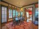 Elegant dining room features wood floors, a decorative chandelier, and large windows offering ample natural light at 3299 Carmichael Pl, Duluth, GA 30097