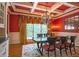 Elegant dining room with coffered ceiling, red walls, chandelier, and natural light at 3299 Carmichael Pl, Duluth, GA 30097