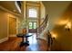 Grand foyer with hardwood floors, curved staircase, and a large arched window at 3299 Carmichael Pl, Duluth, GA 30097
