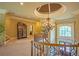 Beautiful foyer with a crystal chandelier hanging from an elegant dome, crown molding, and a curved wooden staircase at 3299 Carmichael Pl, Duluth, GA 30097
