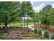 Overlooking the golf course, this property boasts lush greenery and mature trees at 3299 Carmichael Pl, Duluth, GA 30097