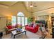 Bright living room with vaulted ceiling, large windows, and comfortable seating arrangement at 3299 Carmichael Pl, Duluth, GA 30097