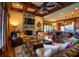 Cozy living room featuring a stone fireplace, beamed ceiling, and breakfast bar at 3299 Carmichael Pl, Duluth, GA 30097