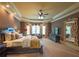 Primary bedroom showcasing sitting area, large bed, and TV at 3299 Carmichael Pl, Duluth, GA 30097