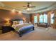 Spacious primary bedroom featuring sitting area, bay window, and decorative ceiling at 3299 Carmichael Pl, Duluth, GA 30097