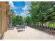 Large patio with metal table and chairs overlooking a manicured lawn and green landscape at 3299 Carmichael Pl, Duluth, GA 30097