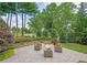 Relax on the stone patio with outdoor seating, surrounded by lush landscaping at 3299 Carmichael Pl, Duluth, GA 30097