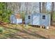 Two storage sheds and surrounding green space in a well-maintained backyard at 3868 Sharon Dr, Powder Springs, GA 30127