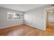 Bedroom featuring wood floors, neutral walls, and a window with blinds for natural light at 1445 Monroe Ne Dr # 14F, Atlanta, GA 30324