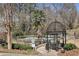 Community pool area featuring a charming gazebo, seating, and beautiful natural surroundings at 1445 Monroe Ne Dr # 14F, Atlanta, GA 30324