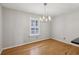 Dining area showcasing hardwood floors, a stylish light fixture, and a bright window at 1445 Monroe Ne Dr # 14F, Atlanta, GA 30324