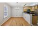 Bright dining room with hardwood floors, modern lighting fixture, and natural light at 1445 Monroe Ne Dr # 14F, Atlanta, GA 30324