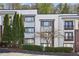 Modern condo building with well-maintained landscaping, mature trees, and a tranquil setting at 1445 Monroe Ne Dr # 14F, Atlanta, GA 30324