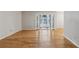 Spacious living room featuring hardwood floors and a light-filled sunroom beyond double doors at 1445 Monroe Ne Dr # 14F, Atlanta, GA 30324