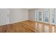 Bright living room with hardwood floors, white trim, and entrance to the balcony at 1445 Monroe Ne Dr # 14F, Atlanta, GA 30324