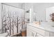 Well-lit bathroom featuring a white vanity, decorative shower curtain, and modern fixtures at 2638 Songbird Ln, Grayson, GA 30017