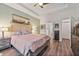 Spacious bedroom featuring wood floors, tray ceiling, and ensuite bath access at 2638 Songbird Ln, Grayson, GA 30017