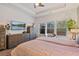 Bright bedroom showcasing wood floors, a ceiling fan, and a view to the exterior at 2638 Songbird Ln, Grayson, GA 30017