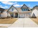 Charming, Craftsman-style home with a well-manicured lawn, covered porch and two car garage in a desirable neighborhood at 2638 Songbird Ln, Grayson, GA 30017