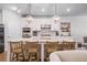 A kitchen island with white base, granite top and pendant lights is the focal point at 2638 Songbird Ln, Grayson, GA 30017