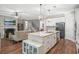 Bright, open kitchen featuring an island with granite countertops and stainless steel appliances at 2638 Songbird Ln, Grayson, GA 30017