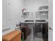 Modern laundry room with front-load washer and dryer, plus ample shelving for organized storage at 2638 Songbird Ln, Grayson, GA 30017