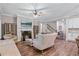 Spacious living room with a fireplace, hardwood floors, and seamless access to the dining area at 2638 Songbird Ln, Grayson, GA 30017
