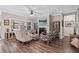 Open-concept living room with a fireplace, large windows, and modern furnishings at 2638 Songbird Ln, Grayson, GA 30017