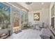 Bright sun room surrounded by windows, offering natural light and views of the landscaped yard at 2638 Songbird Ln, Grayson, GA 30017