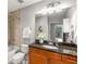 Well-lit bathroom with granite countertops, a vanity, and a shower/tub combo at 855 Peachtree Ne St # 1906, Atlanta, GA 30308