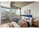Bright bedroom with a large window and balcony offering stunning city views at 855 Peachtree Ne St # 1906, Atlanta, GA 30308