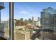 Stunning city view seen from a high-rise window showcases Atlanta's architecture and skyline on a bright day at 855 Peachtree Ne St # 1906, Atlanta, GA 30308