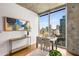 Bright dining room with city views from a large window and modern decor at 855 Peachtree Ne St # 1906, Atlanta, GA 30308