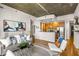 Bright, open concept living room and kitchen with concrete ceiling and hardwood floors at 855 Peachtree Ne St # 1906, Atlanta, GA 30308