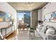 Living and dining area featuring city views, hardwood floors, and modern furnishings at 855 Peachtree Ne St # 1906, Atlanta, GA 30308