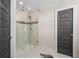 Modern glass shower stall with tile detail and tile flooring in updated bathroom at 2011 Braeburn Se Cir, Atlanta, GA 30316