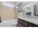 Bathroom features a tub-shower, modern vanity, and granite counters at 2011 Braeburn Se Cir, Atlanta, GA 30316