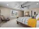 Bright bedroom features large windows, neutral walls, vaulted ceiling with fan, and patterned bedding at 2011 Braeburn Se Cir, Atlanta, GA 30316
