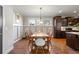 Traditional dining area featuring hardwood floors, paneled walls, and modern lighting fixture at 2011 Braeburn Se Cir, Atlanta, GA 30316