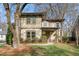 Attractive home with a covered front porch and a well-manicured lawn with mature trees at 2011 Braeburn Se Cir, Atlanta, GA 30316