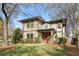 Charming two-story home featuring stone accents, a covered porch, and mature landscaping at 2011 Braeburn Se Cir, Atlanta, GA 30316